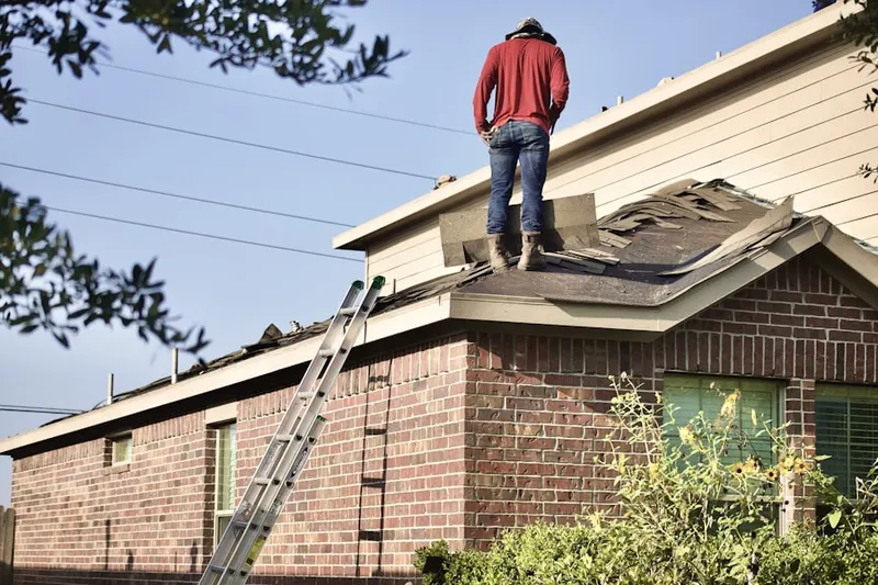 Professional roofer working on a residential roof in Lynbrook